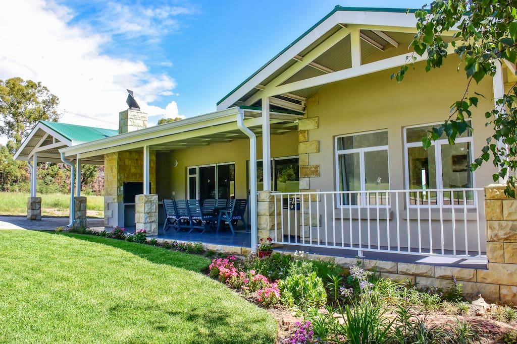 Front of house showing undercover patio, braai and outdoor seating