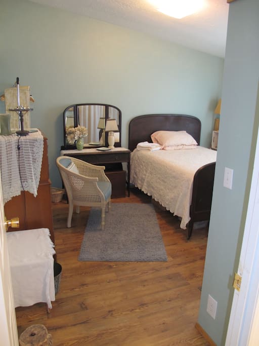 NW Room with double bed, chair, vanity with mirror(surface area may be used for laptop)