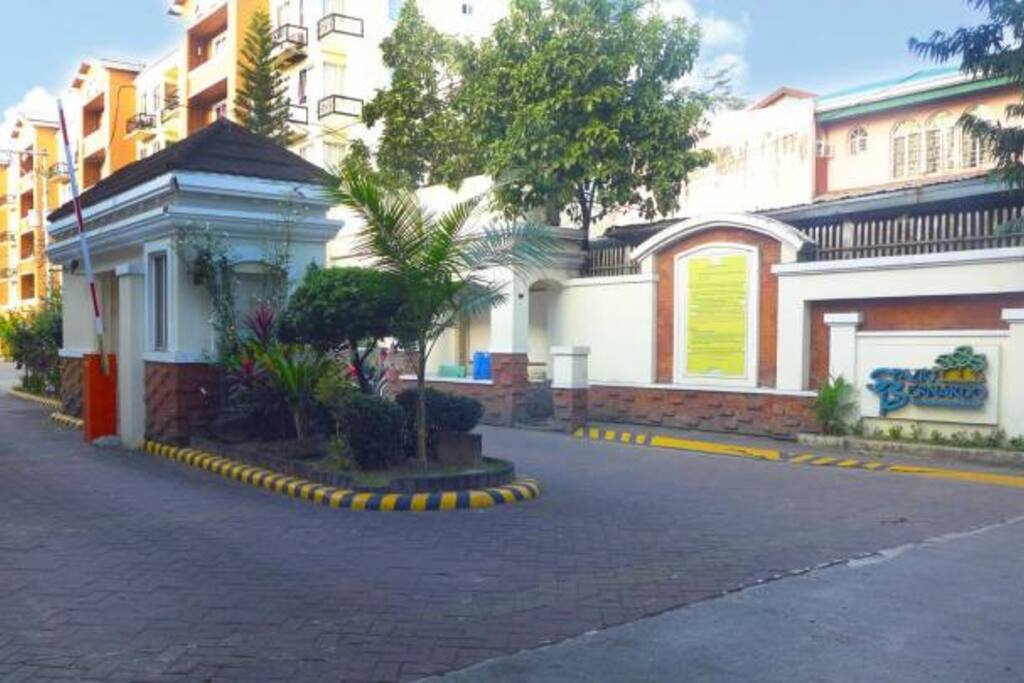 Front gate w/ 24/7 Security guards, where taxi cabs and tricycles await passengers.