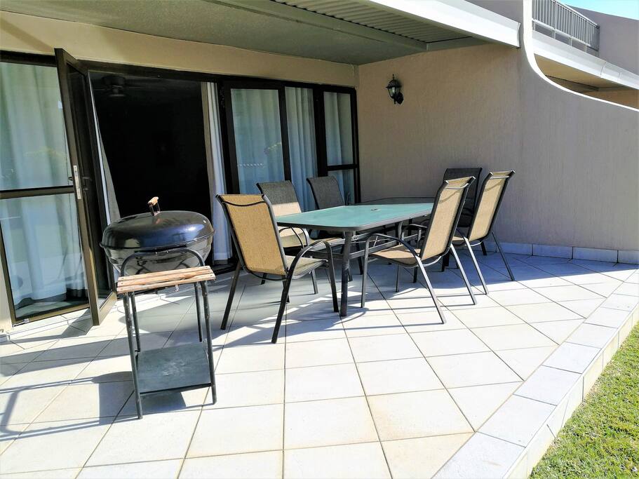 Patio with braai barbeque. The patio is off the lounge, and leads onto the garden and pool area.