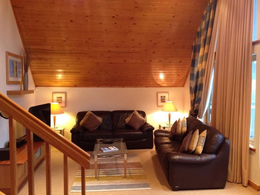 The split level lounge with floor to ceiling windows and high quality TV and Sound System.