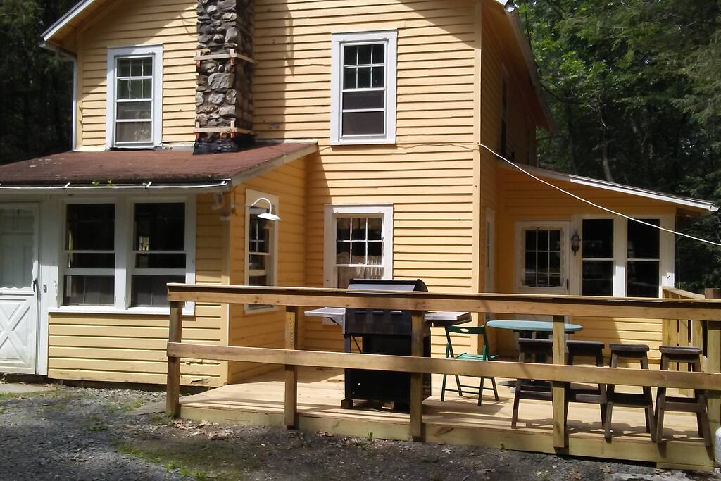 Front foyer to kitchen (left) access to wrap around porch (right) BBQ replaced w/Hibachi inside porch.