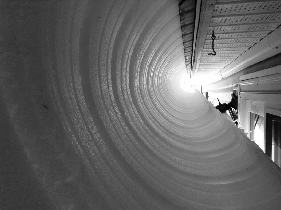 Snow sliding off of the rooftop, s l o w l y.