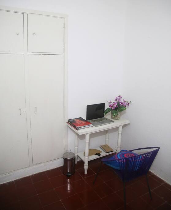 Closet in one of the bedrooms with bedside table. It can be used as a desk.
