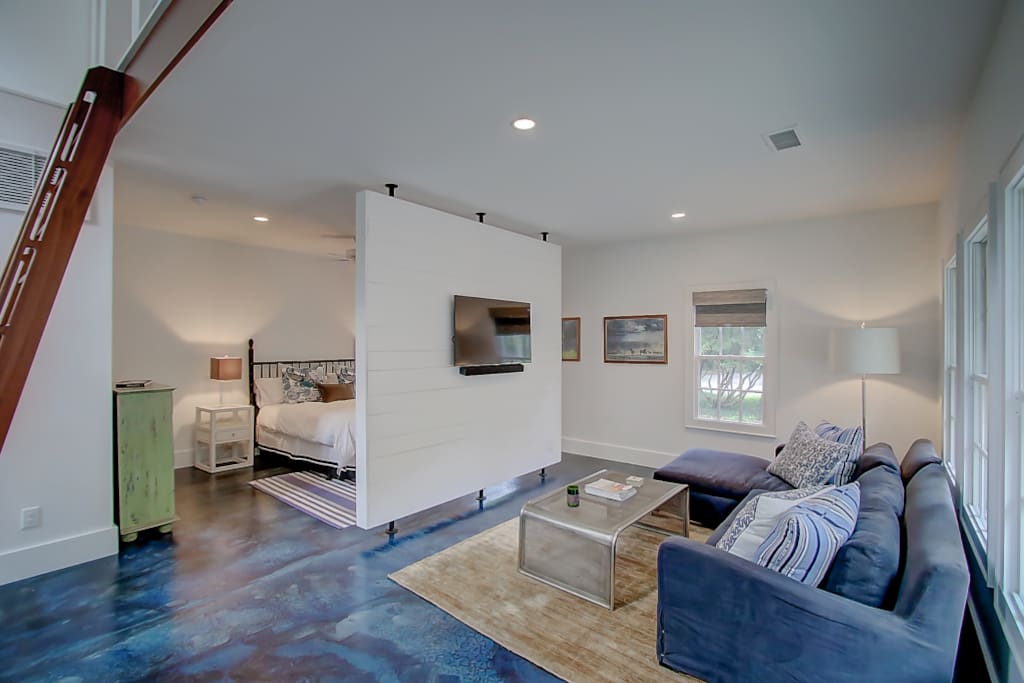Open living area with wall separating the bedroom.