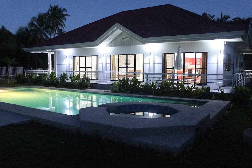 Night view of the pool and the house.