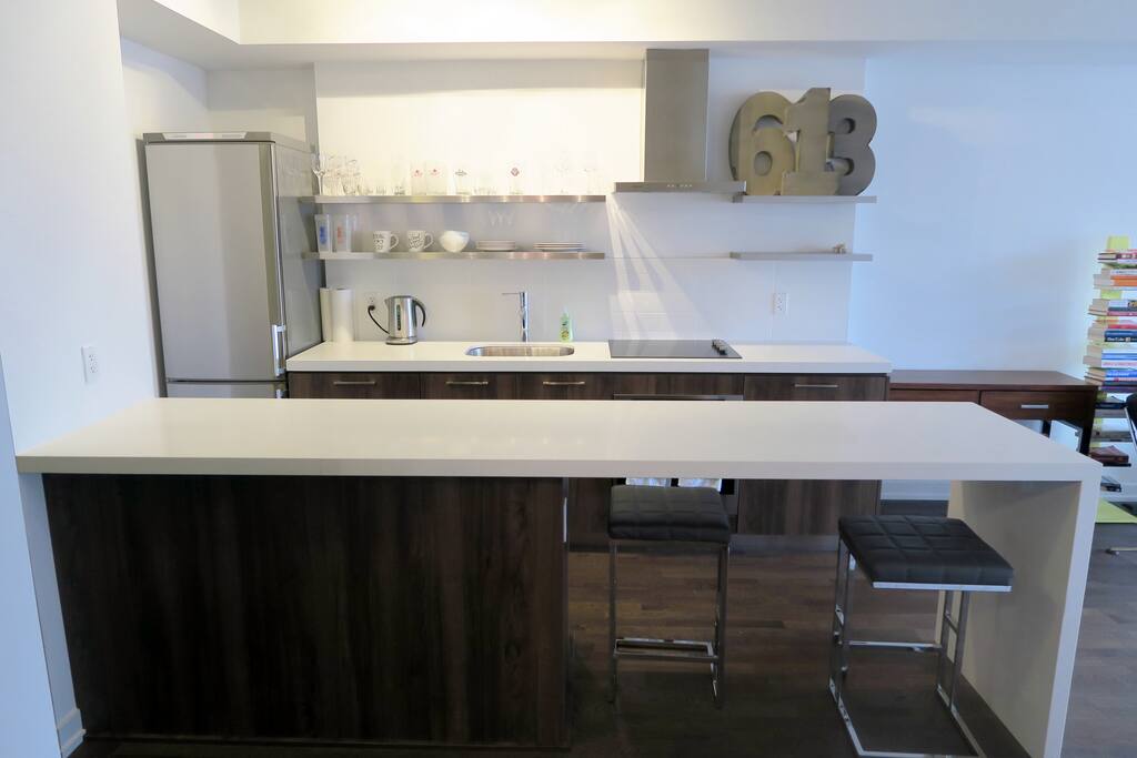 Modern kitchen & bar with 2 stools