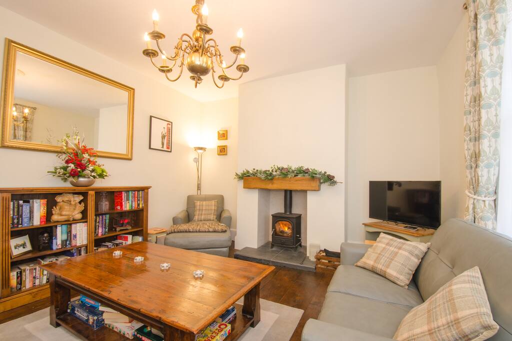 Living room, furniture arranged around a large oak table.