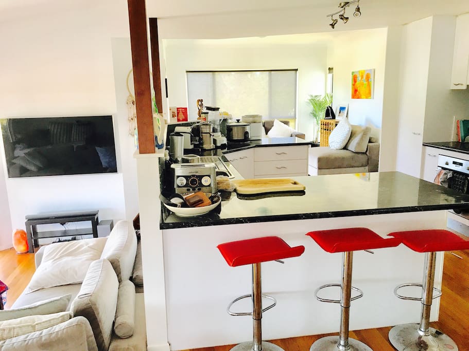 Lounge, kitchen and dining areas. Additional lounge behind the kitchen and indoor dining table with high chair available.