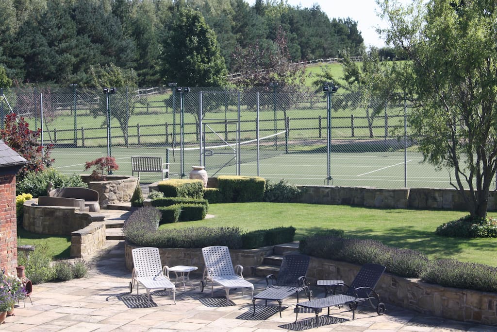 Extensive gardens with floodlit tennis court
