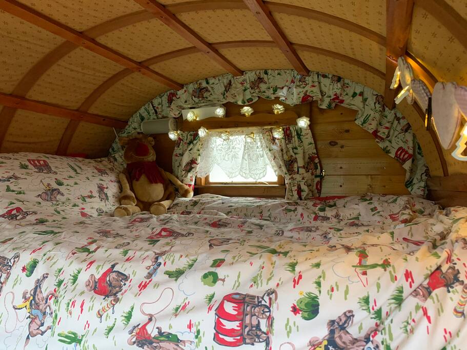 Mabel is looking magnificent... cupboard under bed for storage; ideal for teeny tiny: miniature: small doggie room; (just let me know and I'll provide creature comforts; dog bed, towel, bowls and treats! Extra charge £10 per dog per stay)
Small nightlight and rose fairy lights complement Cath Kidson rose or cowboy bedding. Flickering battery tea lights for safety are now installed as no smoking or candles please. Please do bring AA batteries!