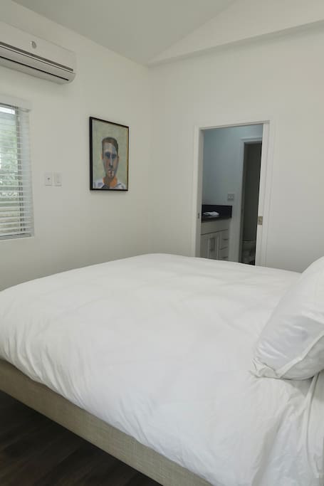 Bedroom with king bed and upholstered headboard