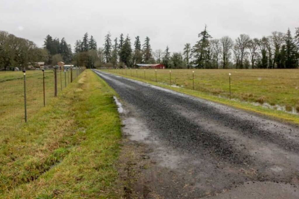 Wide gravel road entrance.