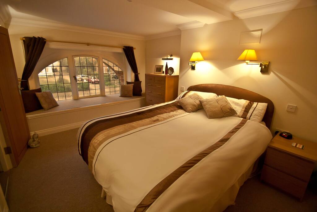 Master bedroom with king size bed and feature window