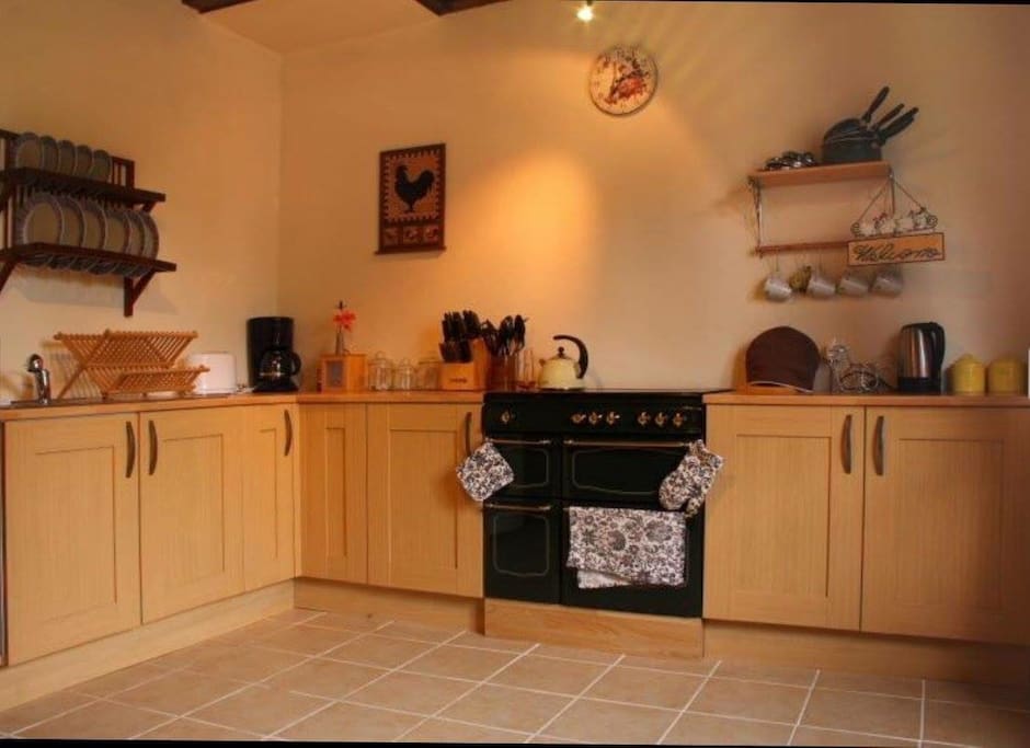 Full kitchen with large oven and fridge