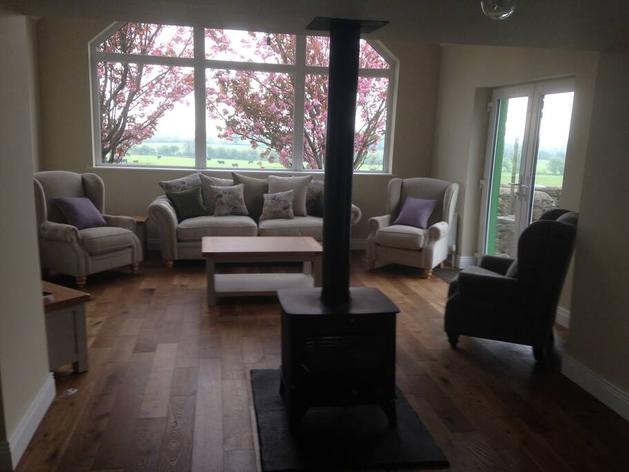 Newly renovated interior with traditional center stove pipe fireplace.