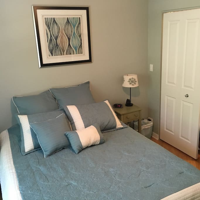 Queen bed with nightstand and half the closet door