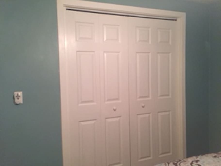 1 of 2 bedrooms. Showing closet doors and also remote on wall for the bedroom ceiling fan. (You can increase or decrease the ceiling fan speed when you are laying in bed. (One of the greatest inventions ever!)