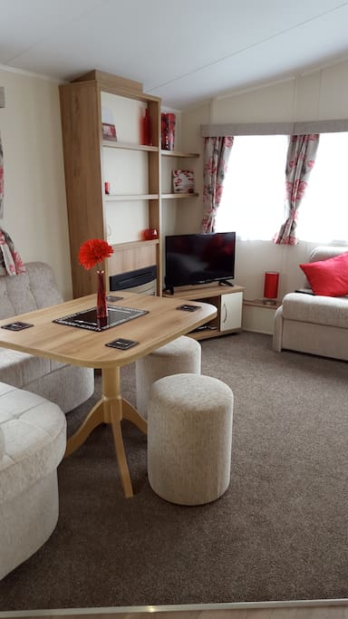 Living area with LED TV, DVD and CD player, a selection of DVD's and a pack of cards for rainy days!