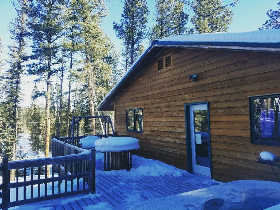 Largest of 3 decks off back of house with 6 person Hot Tub with great views. Outdoor swing furniture and grill.