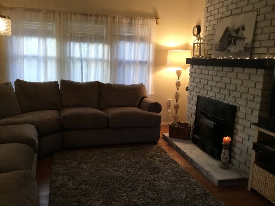 This living room glows in the evening with special lighting or minimal lighting; perfect for cold days and nights when the wood fireplace radiates heat and the sound of the crackling wood draws you into a deep relaxation. There are music systems in this room with a TV that has access to DISH, HULU, Netflix and Amazon Prime.