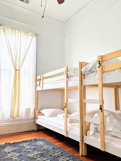 This large room has everything you need for a super comfy stay! Memory foam mattresses, towels, free slippers, ear plugs, lights beside each bed, outlets and USB plugs beside each bed, lockers with locks included, and more. :)