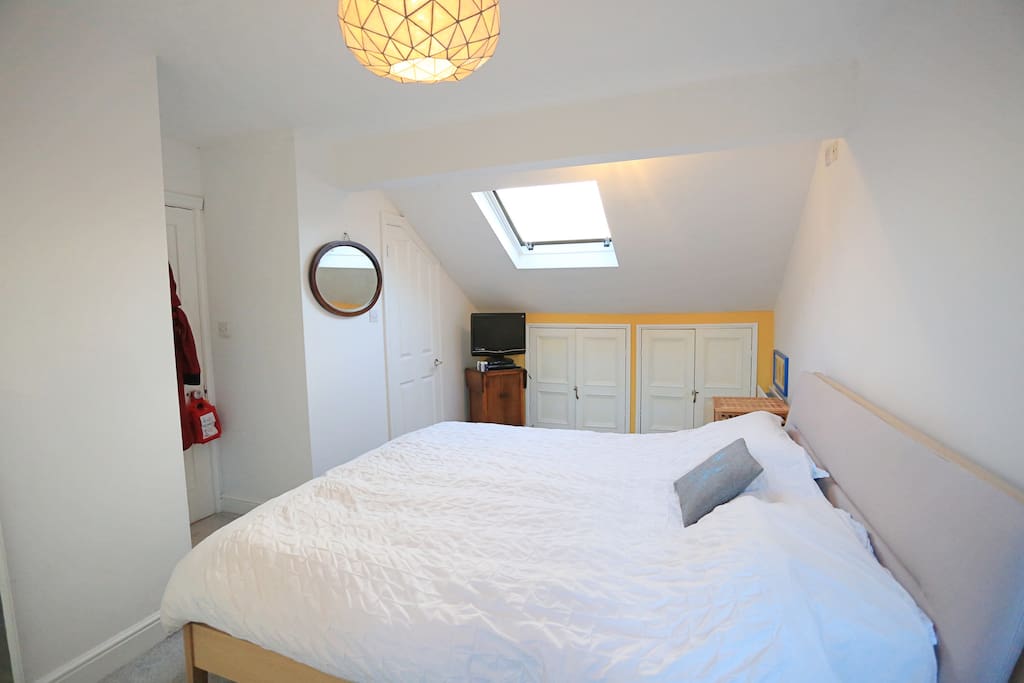Loft bedroom with super kingsized and en suite bathroom. Plenty of room for a child's travel cot.