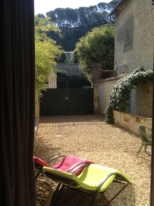 Entrance gate into the intimate courtyard and view of the pines of the ridge