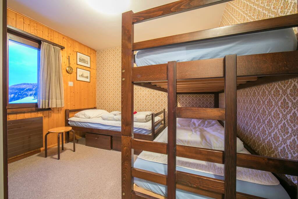 Bedroom with bunk beds and a single sofa