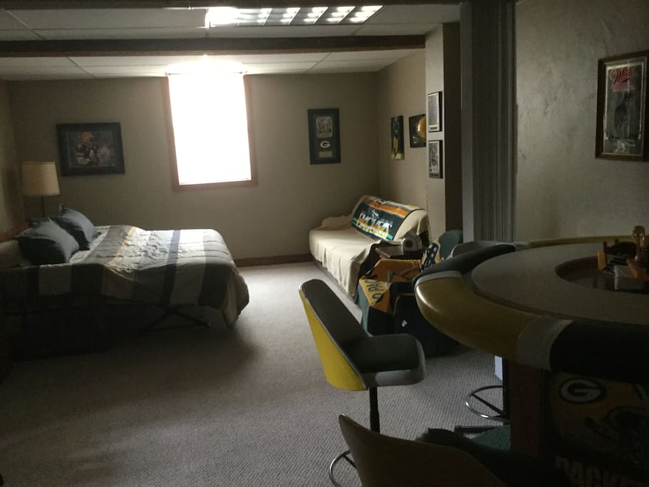 Bedroom with high top table, King size bed, couch for a single sleeper
