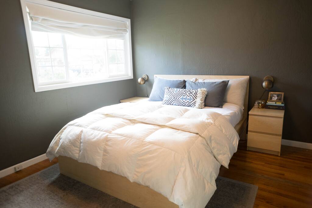 Cozy queen-size bed with down comforter, down pillows, and memory foam topper.