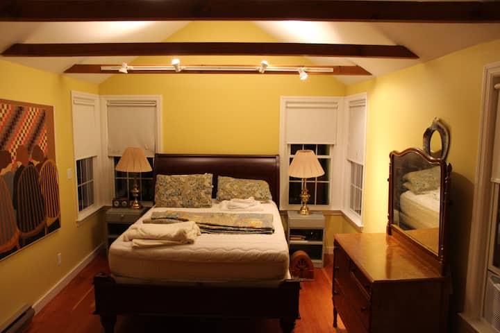 Large master bedroom number three has a loft ceiling and windows all around. 