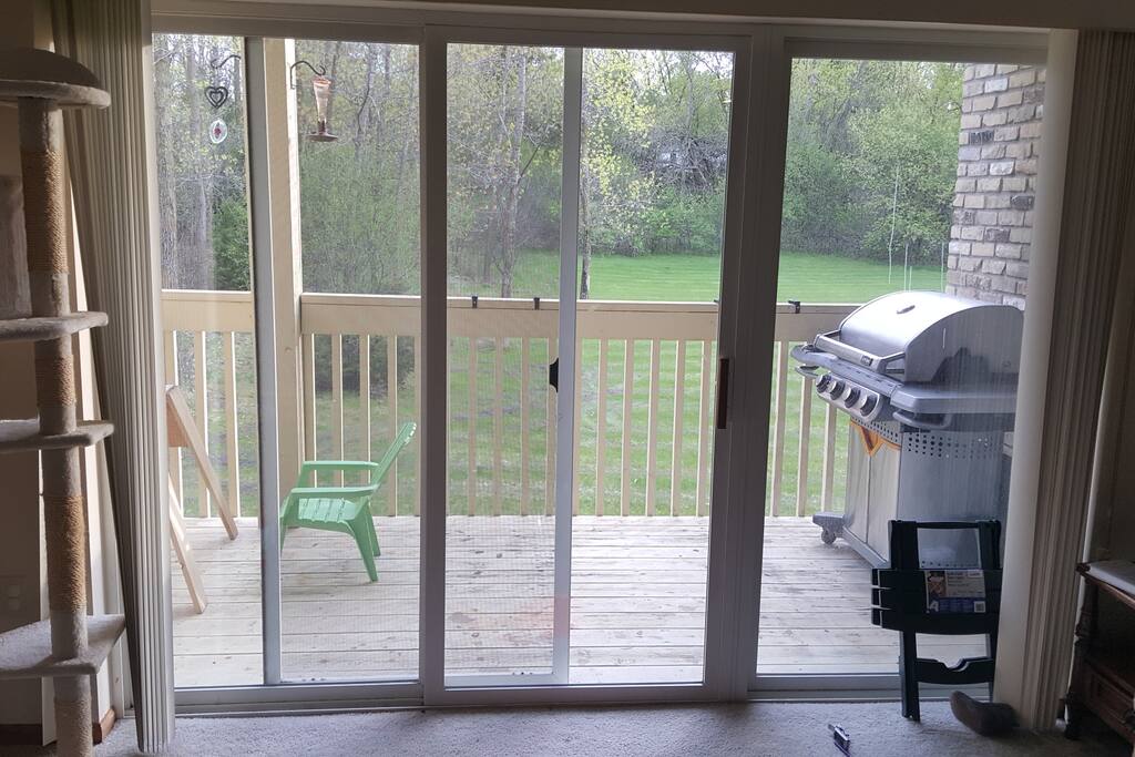 View looking out from living room. Two zero gravity chairs will be on the balcony. Grill is available for using.