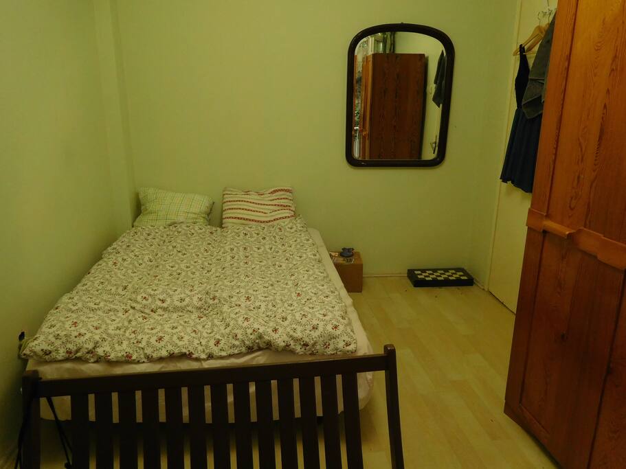Double bed in a large room. There is garderobe for you and a large desk to feel at ease here.
There is also a small balcony on a charming terrasse with trees.