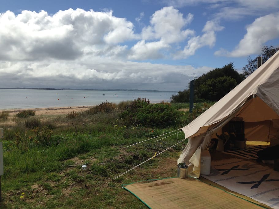 Stumble out of your tent for a swim or a walk on the beach
