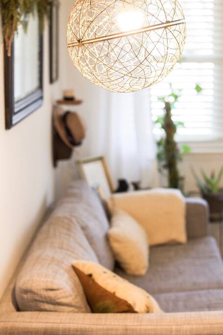 From the front door walk into an airy & bright living space with a record player and bar.