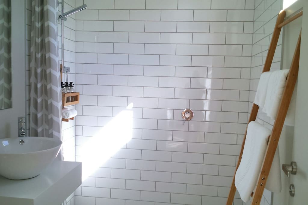Huia ensuite has quality towels, organic products, fan, heater, stylish vanity & sink, & window ++