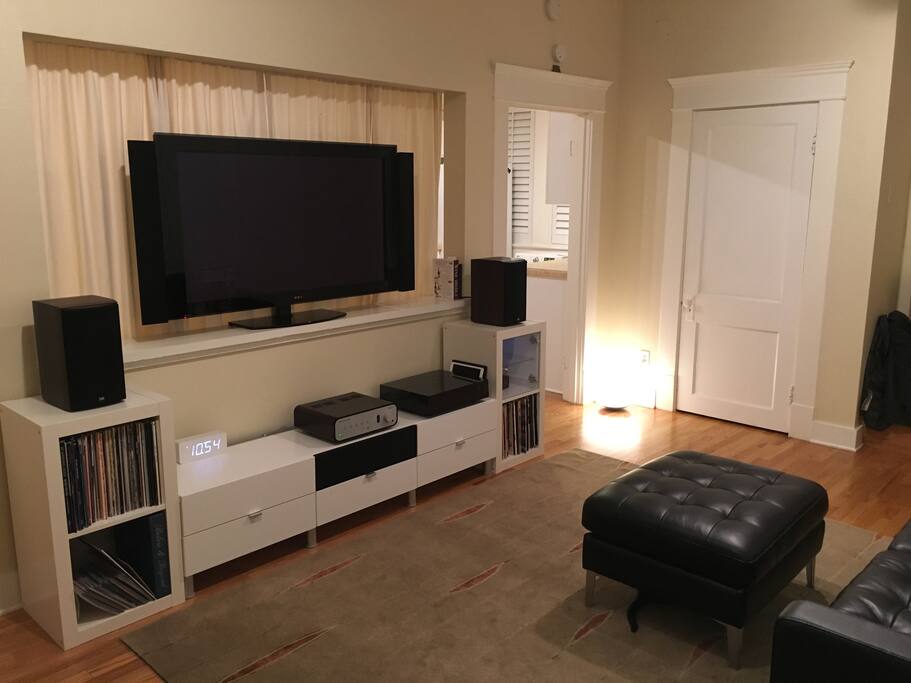 Large flat screen TV, hifi home stereo, turntable, and Apple TV