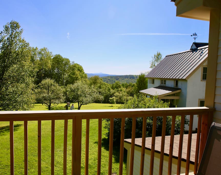 The view to New Hampshire overlooking apple trees and Vermont woods.