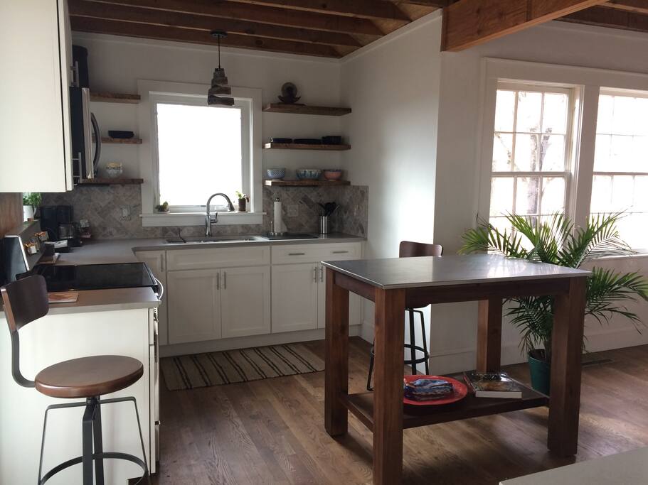Rustic modern kitchen with new cabinets and Caesarstone counter tops, well equipped for cooking and entertaining, all new Samsung appliances, exposed ceiling beams and original oak floors.