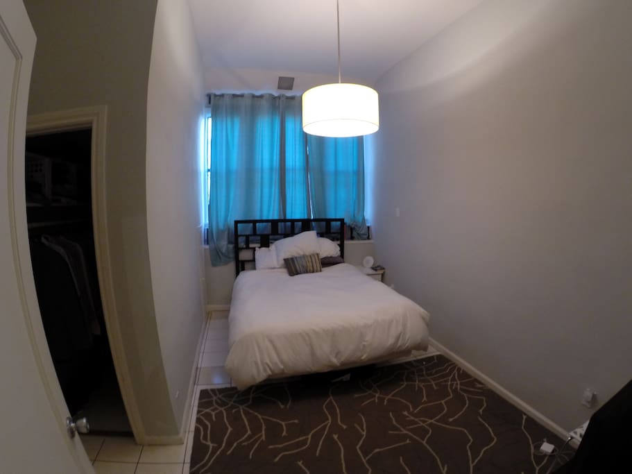 Spacious bedroom with queen size bed, and walk in closet