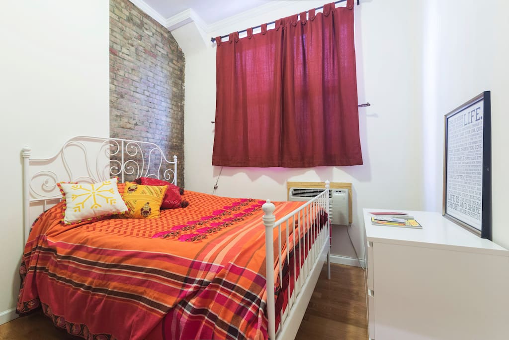The one-bedroom features a bright, comfy Queen-size bed with lots of natural light from the windows.