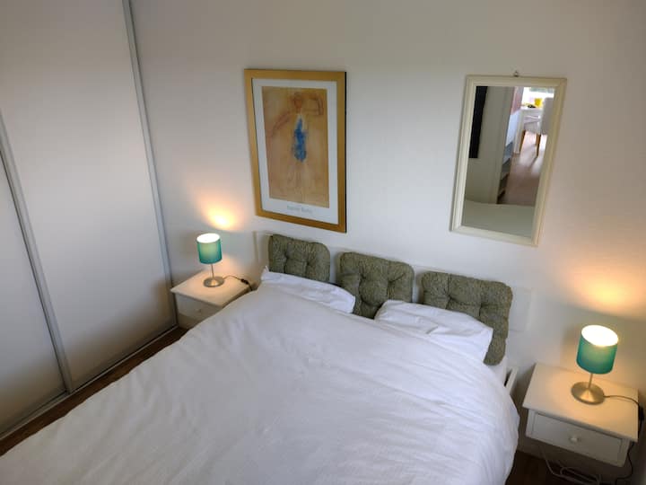 卧室配备一张标准双人床（ 200x140 ）、两张床头柜、一个带五个架子的大衣橱。电暖气和一个吊扇。