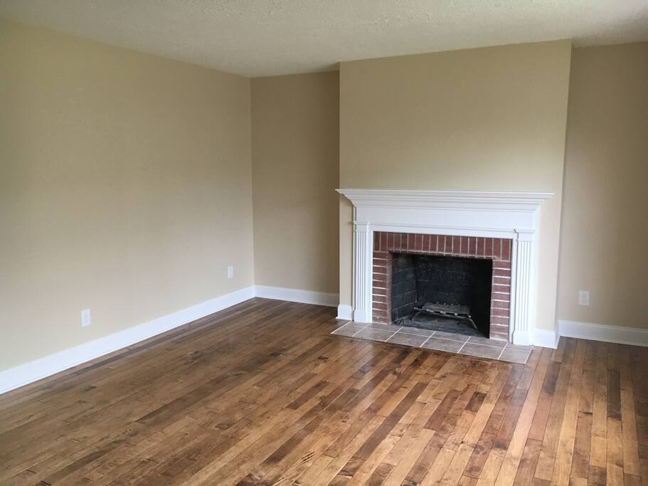 This is the first living room that you will come too upon entering the building. Currently there is not furniture in the home, but with enough warning, it can be there quickly! The fireplace in this room has not been inspected so I would not recommend using it but it is still a quiet place to sit in the warmth and look out the large window to the rhododendrons.