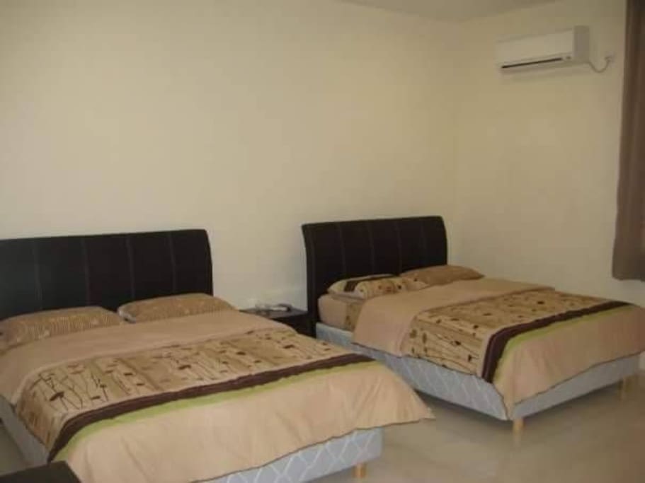This is the master bedroom with two queen sized bed in it. There is a private bathroom for guests in this room. Air conditioning is available in all rooms.