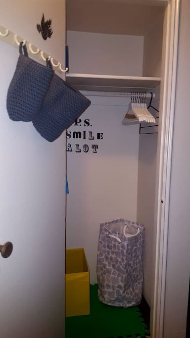Closet with hangers, baskets, hooks and laundry hamper for your convenience