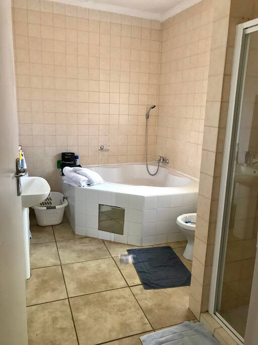 Ensuite bathroom that has a bath tub, shower, toilet and sink