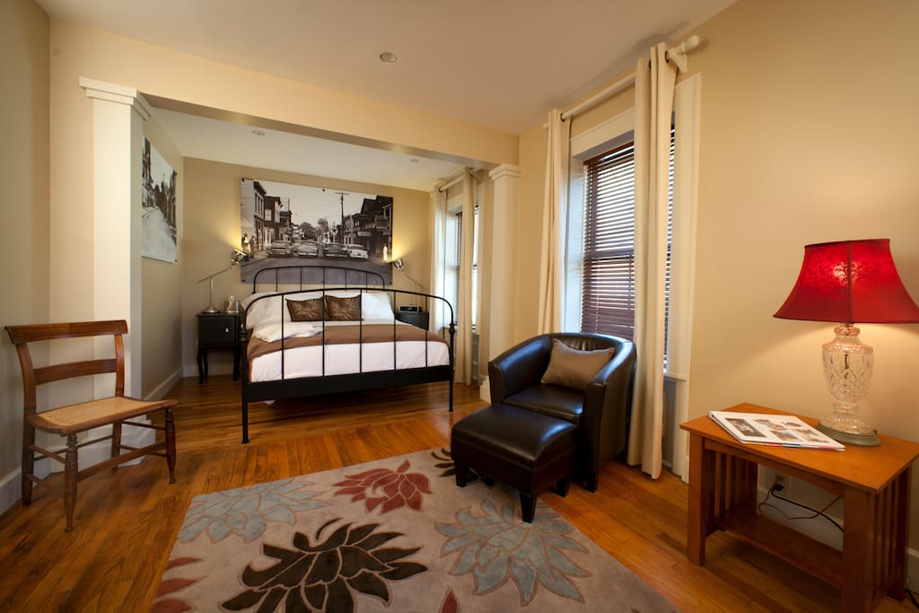 Room Four is a second floor room with a queen bed accommodating two people which offers a village & mountain view
With vintage photos as decor, a queen size bed with comfortable linens, plush towels, spa amenities, flat screen TV & DVD player, beverage cooler, hair dryer, complimentary WiFi, private bath with a tub/shower and guest controlled heat and air conditioning