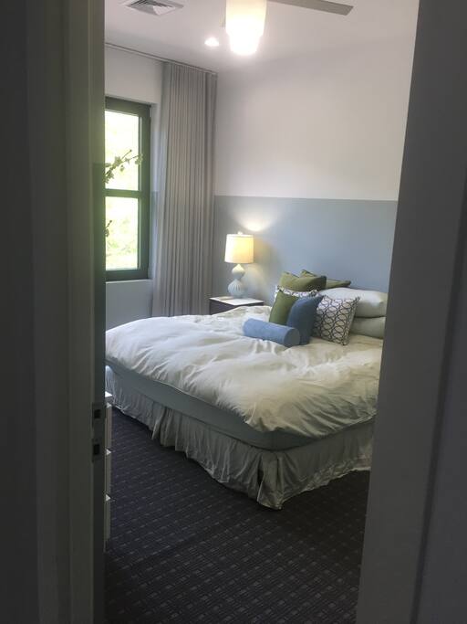 Second floor guest bedroom with king bed, closet and dresser.