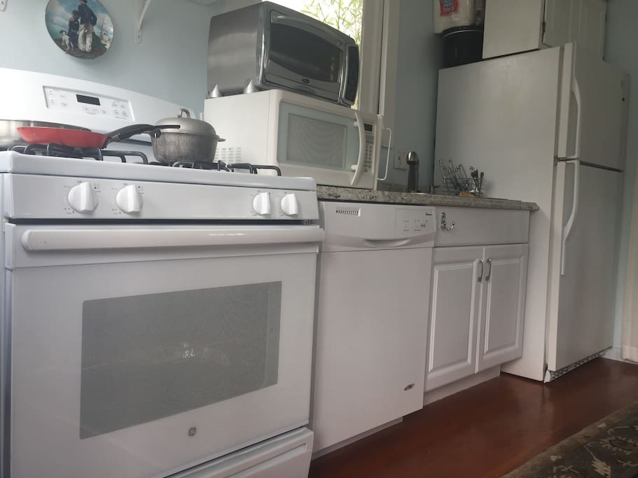 The kitchen is newly renovated with all brand new appliances. It has everything you need, including a stove with gas burners, a dishwasher, full sized refrigerator, microwave, toaster oven, glassware, dishware, silverware, and cutlery.